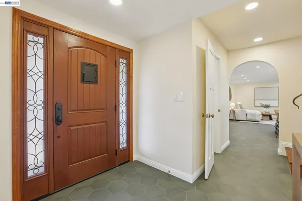 a view of entryway and hall with wooden floor