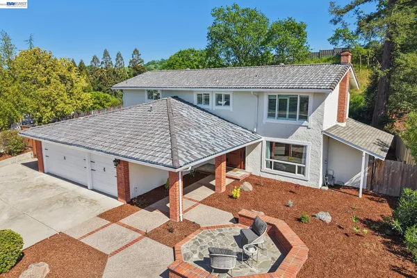 an aerial view of a house with outdoor space and pool view