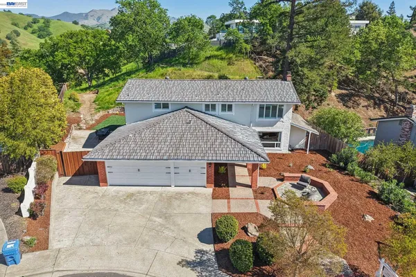 an aerial view of a house with a yard