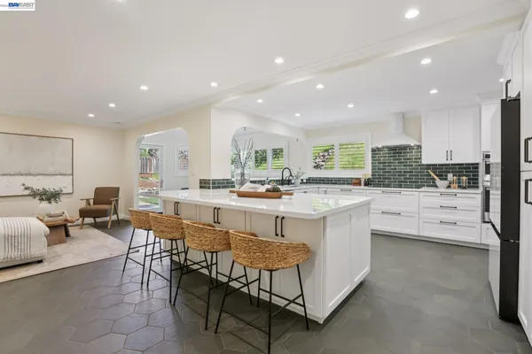 a kitchen with granite countertop white cabinets and white appliances