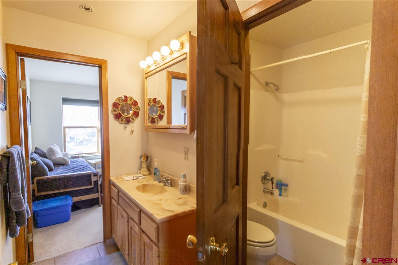 959 1200th Road Delta, CO 81416 - Photo 12 of 34 a en suite bathroom with a sink a toilet and shower