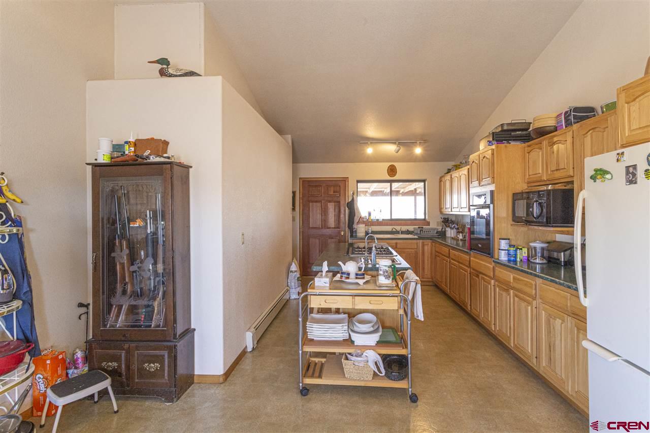959 1200th Road Delta, CO 81416 - Photo 21 of 34 a living room with furniture a chandelier