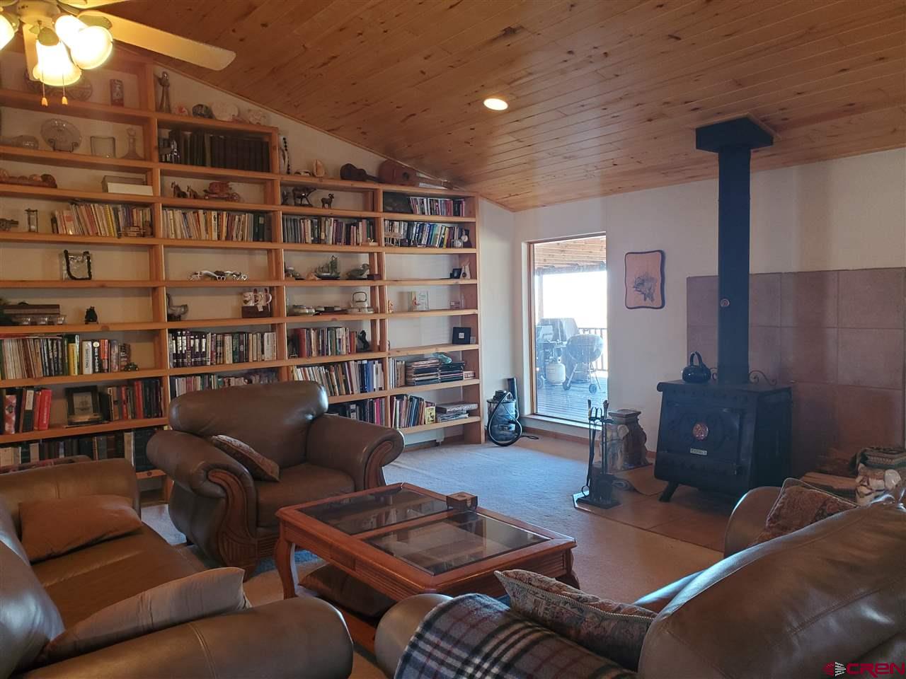 959 1200th Road Delta, CO 81416 - Photo 26 of 34 a living room with furniture and a book shelf