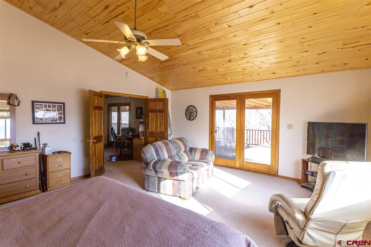 959 1200th Road Delta, CO 81416 - Photo 5 of 34 a living room with furniture a chandelier and a flat screen tv