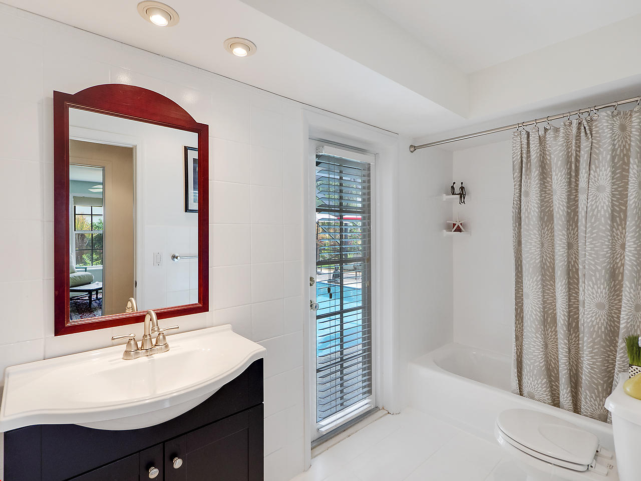 99 Golfview Drive Tequesta, FL 33469 - Photo 12 of 17 a bathroom with a sink a toilet and a mirror