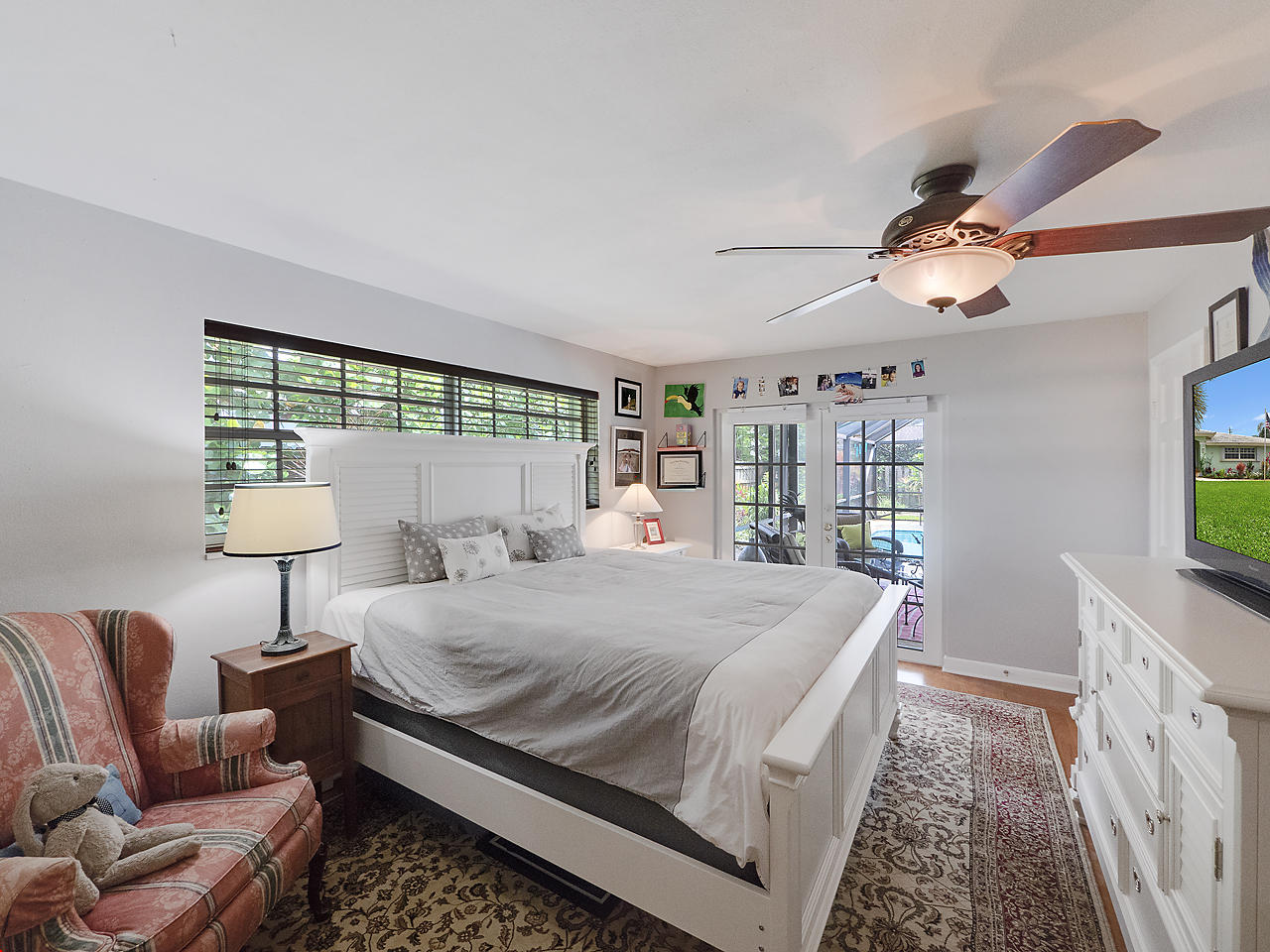 99 Golfview Drive Tequesta, FL 33469 - Photo 15 of 17 a bedroom with a large bed and a chandelier