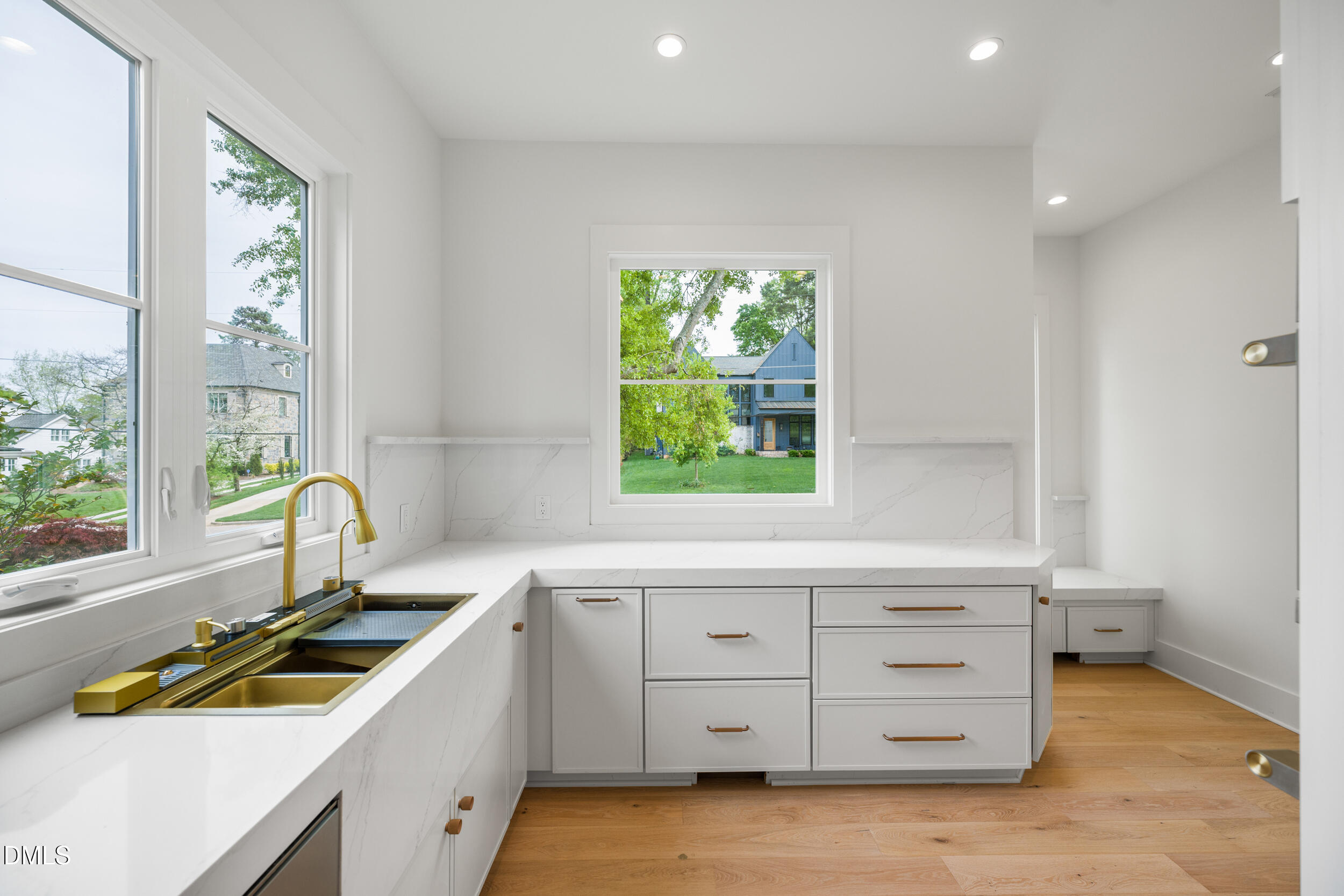 2817 Claremont Road Raleigh, NC 27608 - Photo 23 of 73 a kitchen with sink a window and cabinets