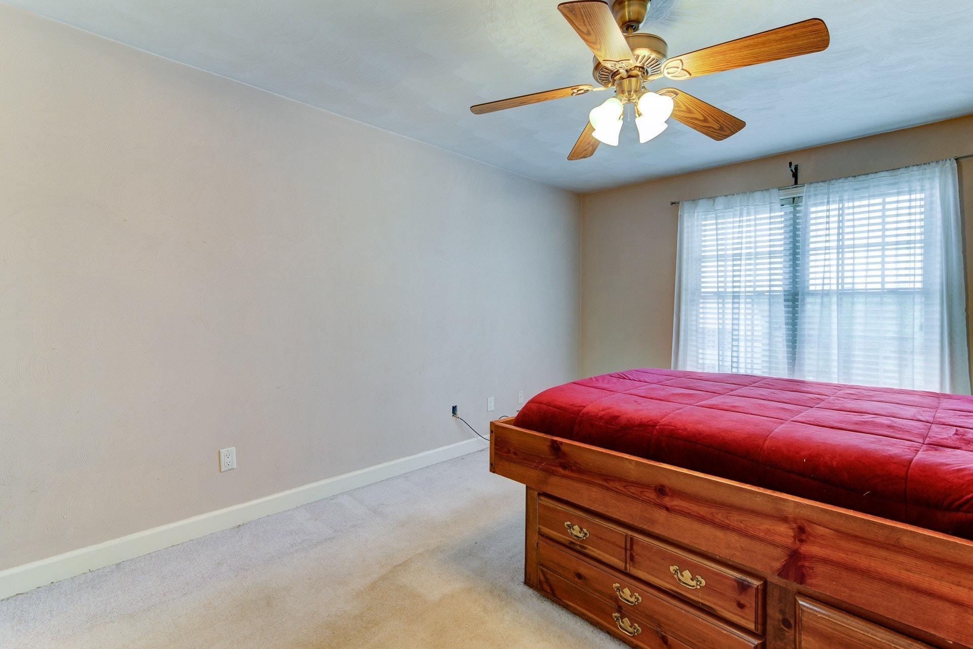 1744 Meadows Road Vinton, VA 24179 - Photo 14 of 36 a room with a bed and a chandelier