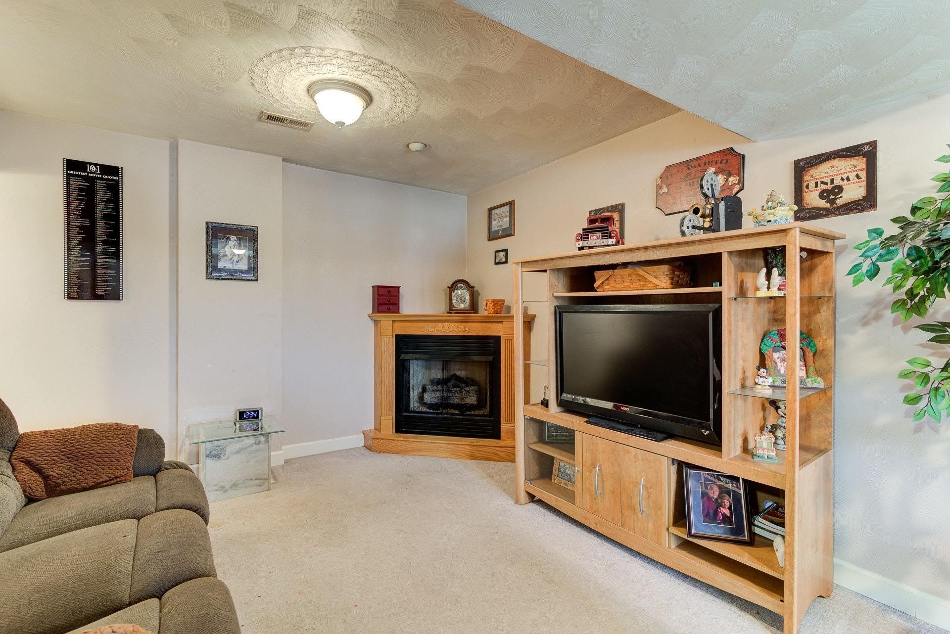 1744 Meadows Road Vinton, VA 24179 - Photo 22 of 36 a living room with furniture and a flat screen tv
