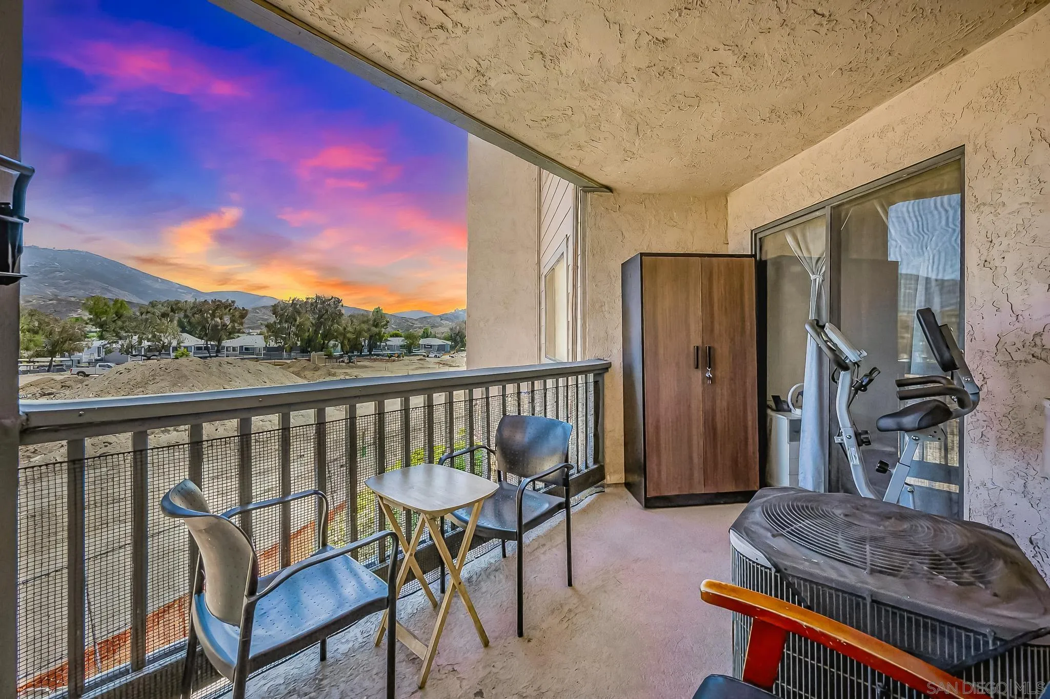 a balcony with table and chairs