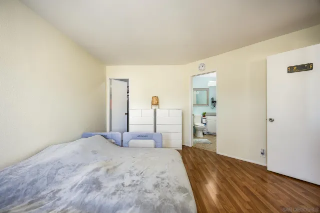 a bedroom with a bed and a mirror