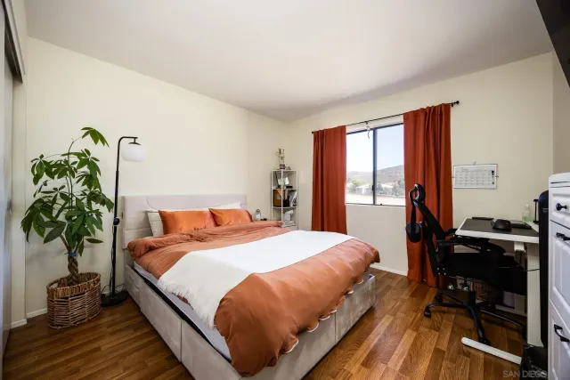 a bedroom with a bed and a potted plant