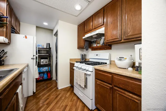 a kitchen with stainless steel appliances granite countertop a stove and a refrigerator