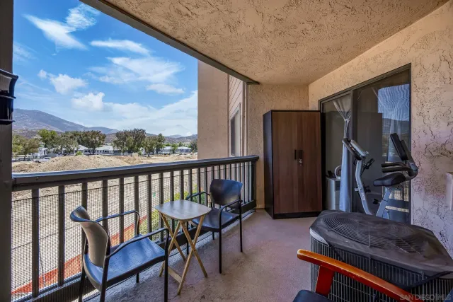 a balcony with table and chairs
