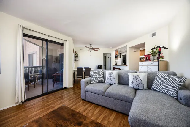 a living room with furniture and a floor to ceiling window