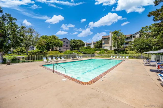 a view of a tennis ground with large trees