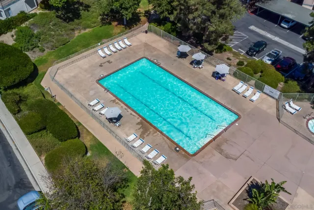 an aerial view of a residential houses with outdoor space and street view