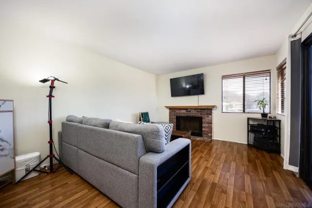 a living room with furniture a fireplace and a flat screen tv