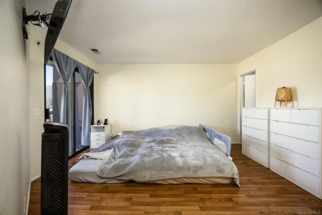 a bedroom with a bed and a dresser