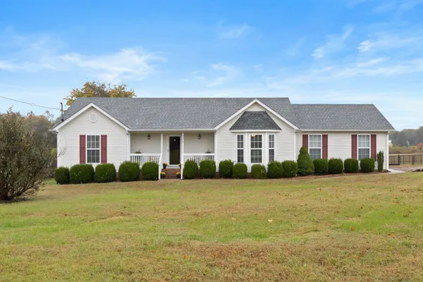 a front view of house with yard and green space