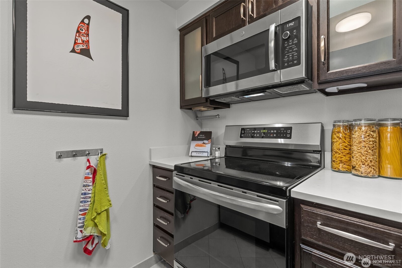 4222 Beach Drive Southwest, Unit 303 Seattle, WA 98116 - Photo 12 of 25 a kitchen with a stove and a microwave