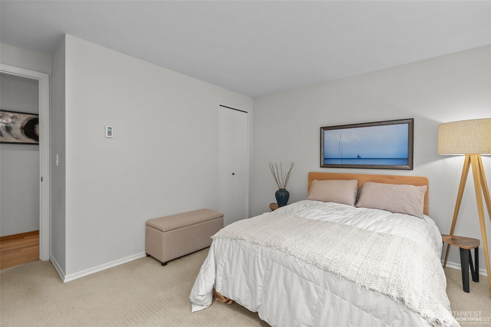 4222 Beach Drive Southwest, Unit 303 Seattle, WA 98116 - Photo 17 of 25 a bedroom with a bed and lamp