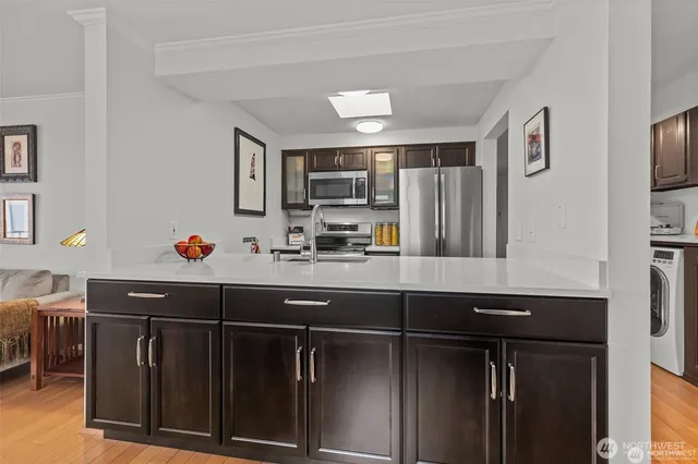 a kitchen with a sink appliances and cabinets