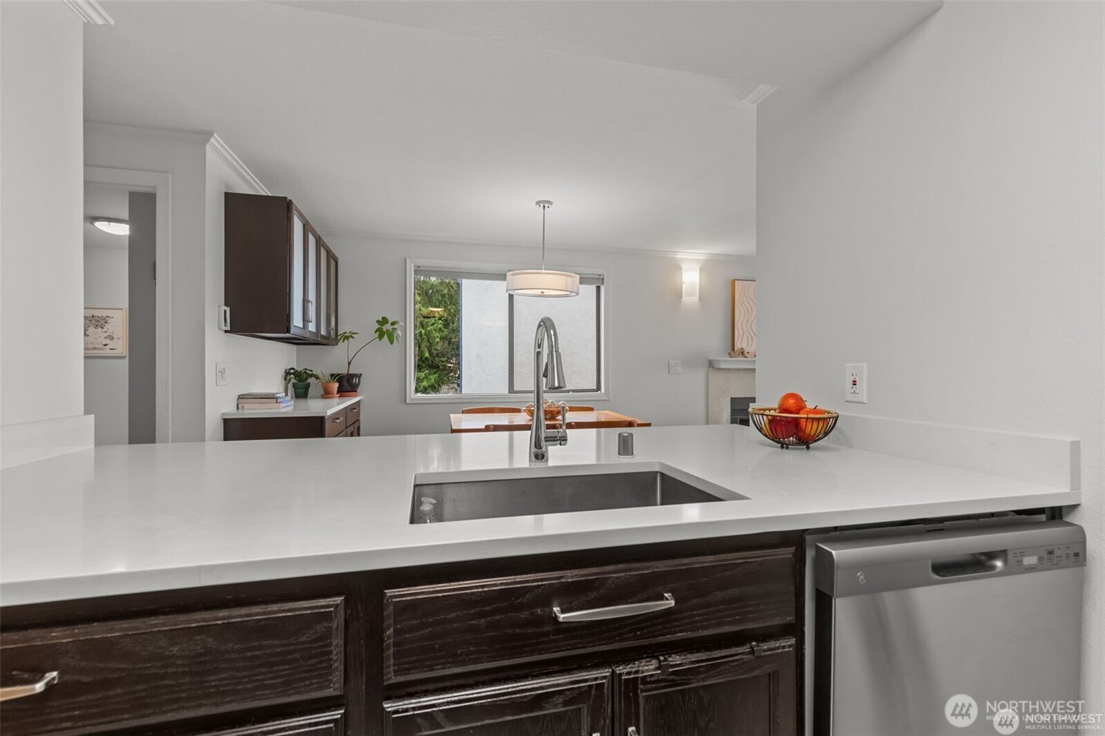 4222 Beach Drive Southwest, Unit 303 Seattle, WA 98116 - Photo 9 of 25 a view of a kitchen with kitchen island a sink appliances and cabinets
