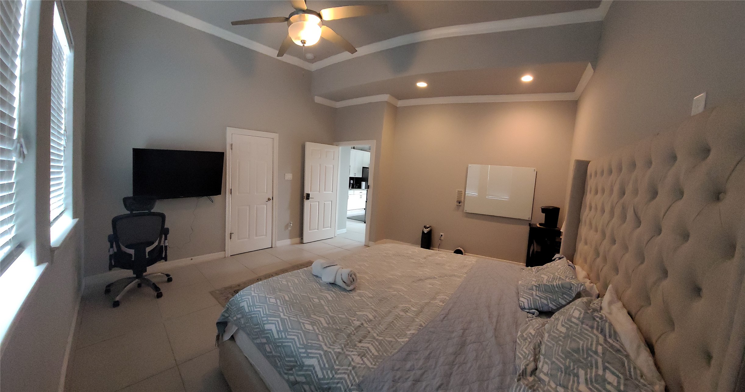 1413 Holly Street, Unit A Houston, TX 77007 - Photo 18 of 33 a bedroom with a bed and a flat tv screen on wall