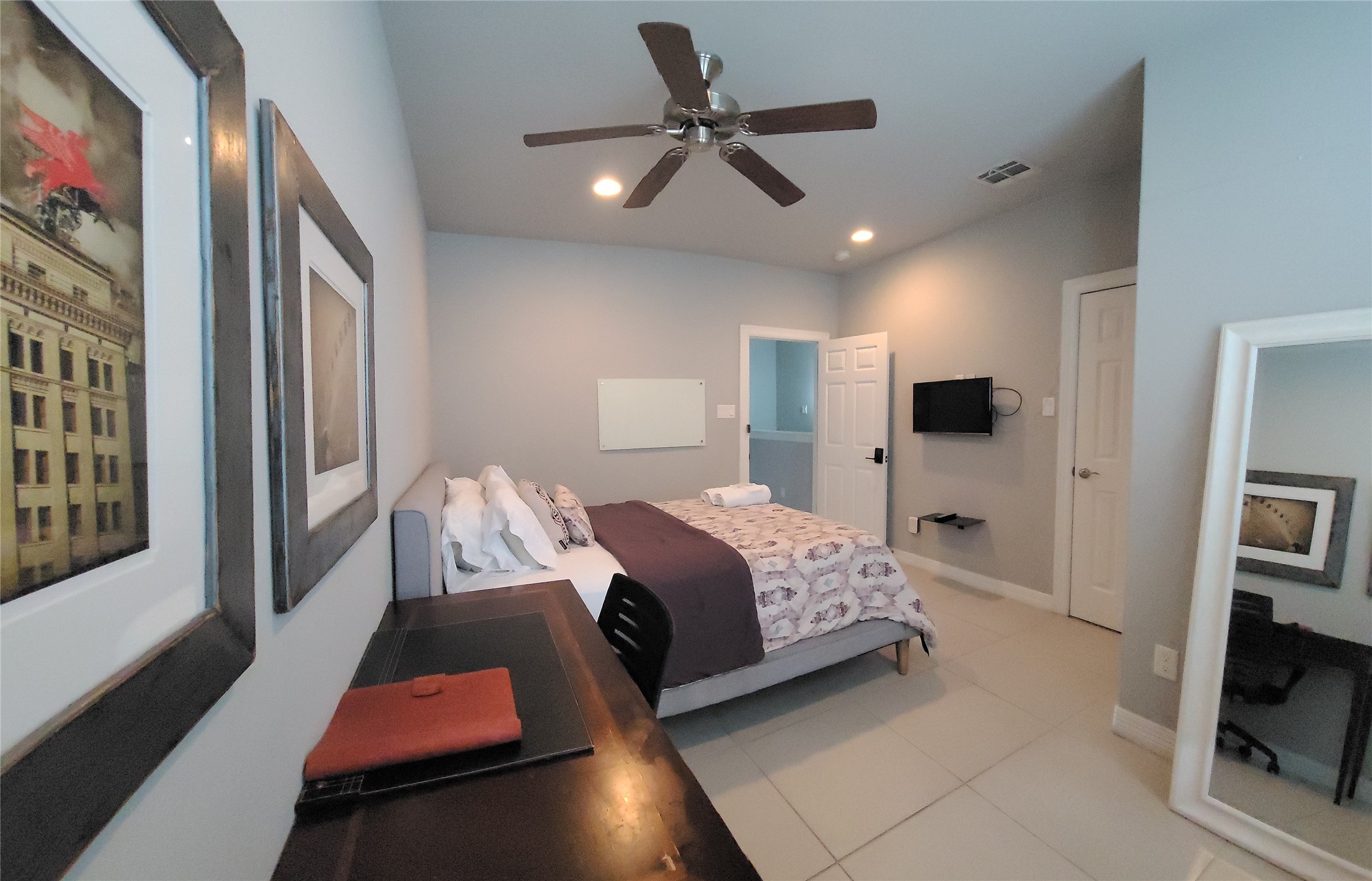 1413 Holly Street, Unit A Houston, TX 77007 - Photo 25 of 33 a bedroom with a bed window and a flat screen tv