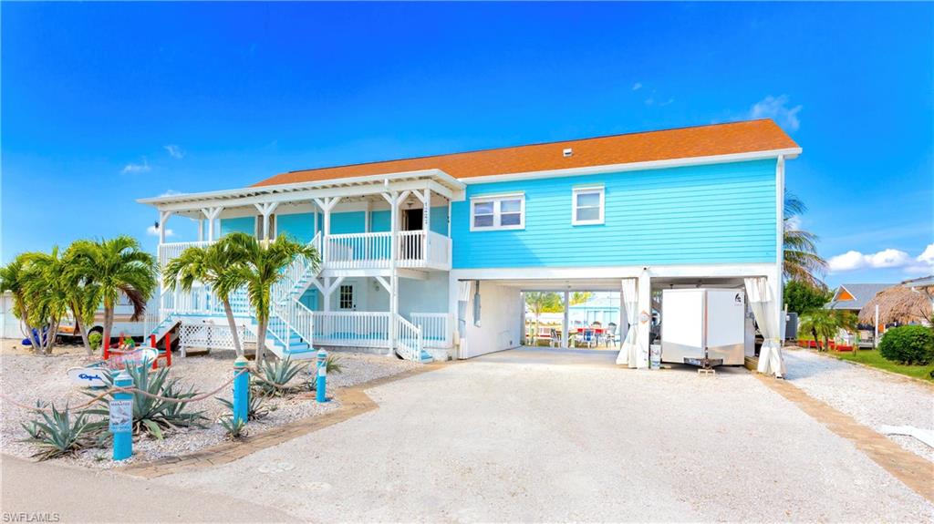 12277 Boat Shell Drive Matlacha Isles, FL 33991 - Photo 5 of 46 a front view of a house with a garden
