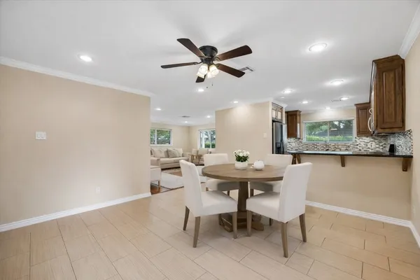 a dining room with a table and chairs