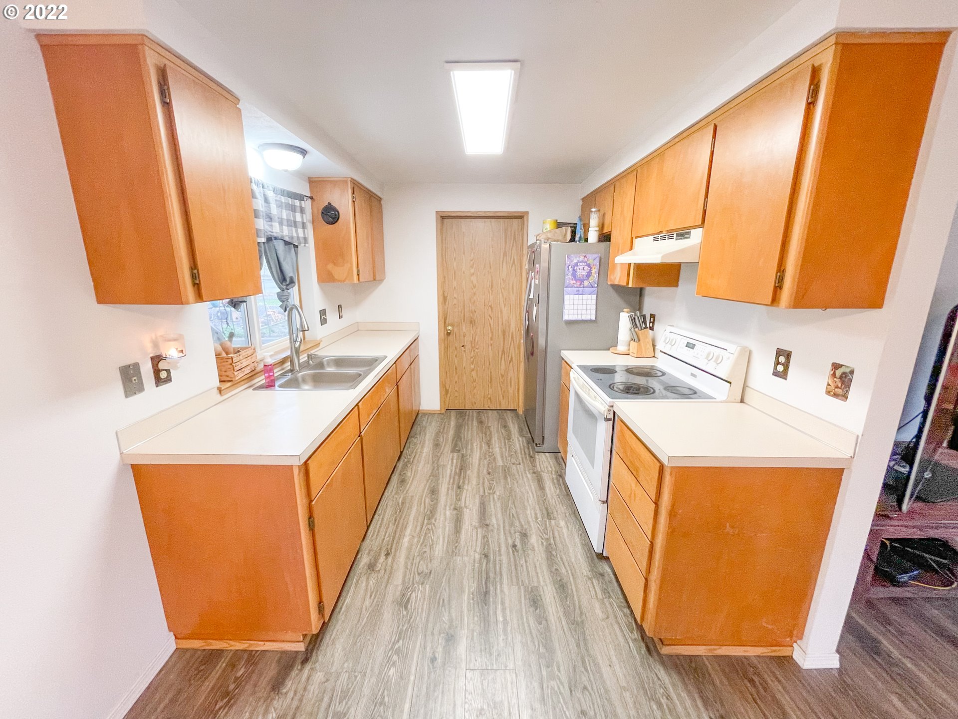 306 Columbia Loop Road Roseburg, OR 97471 - Photo 5 of 17 a view of a kitchen with a sink and wooden floor