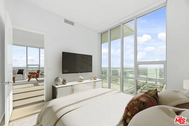 a bedroom with a bed and large window