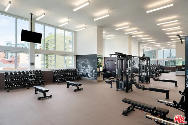 a room with gym equipment and a large window