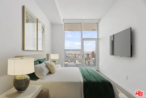 a bedroom with a bed and window