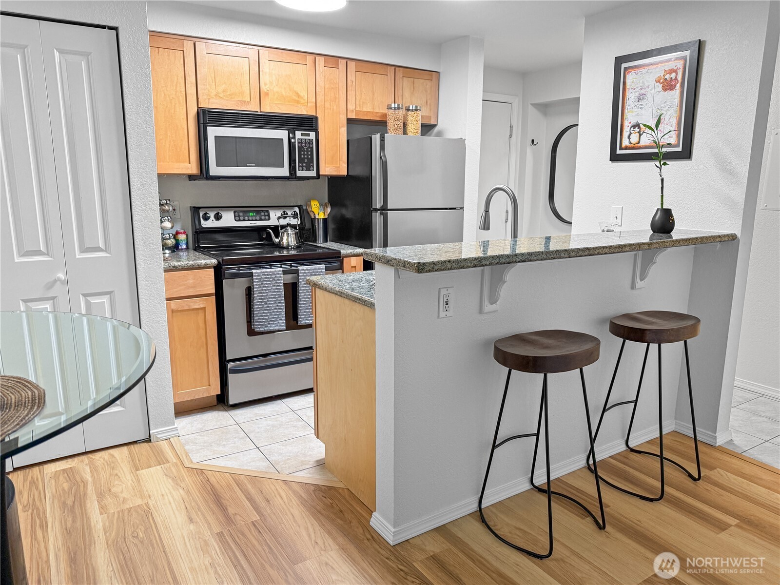 300 10th Avenue, Unit B105 Seattle, WA 98122 - Photo 16 of 40 a kitchen with stainless steel appliances a stove a sink and a refrigerator