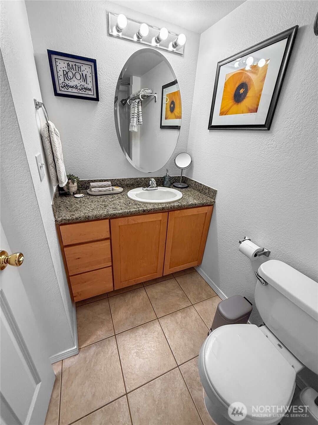 300 10th Avenue, Unit B105 Seattle, WA 98122 - Photo 8 of 40 a bathroom with a toilet a sink and mirror