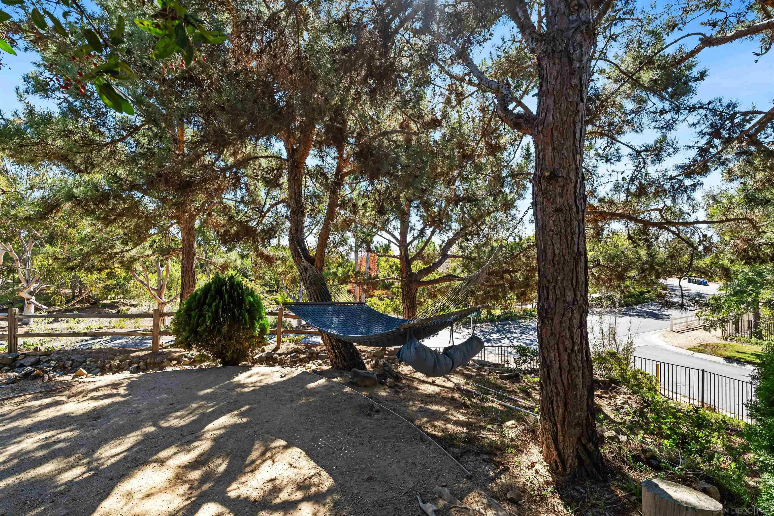 301 Cantle Lane Encinitas, CA 92024 - Photo 46 of 75 a backyard of a house with table and chairs