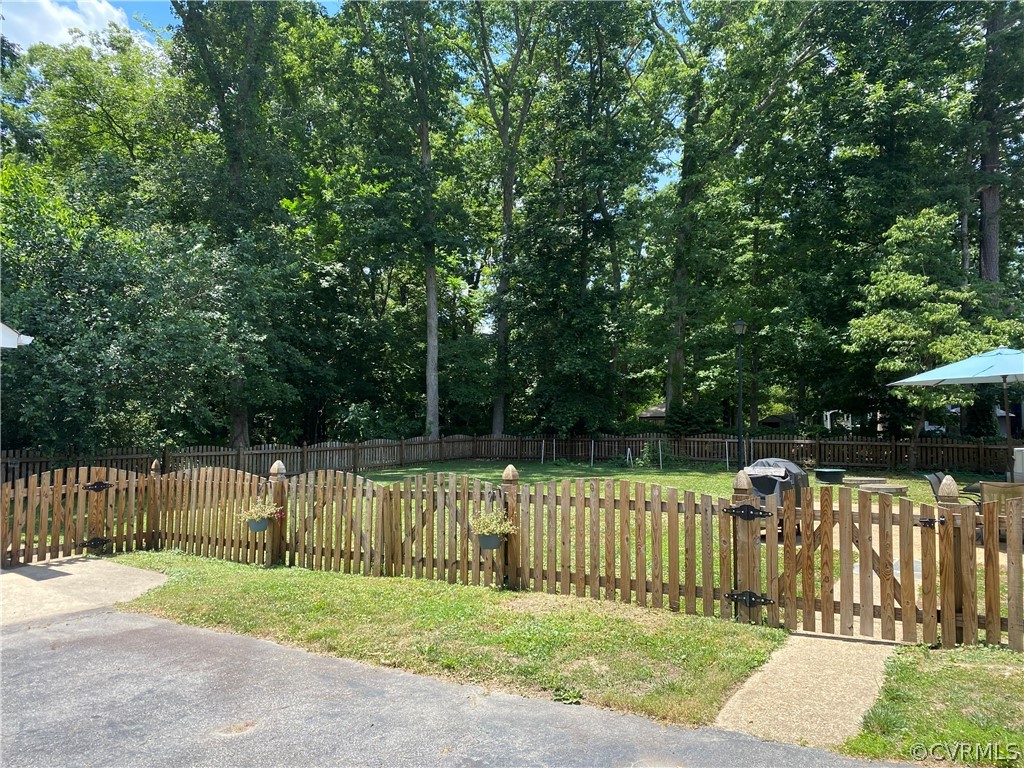 4201 Hidden Valley Road Chester, VA 23831 - Photo 25 of 30 a view of a deck with a small yard and large trees