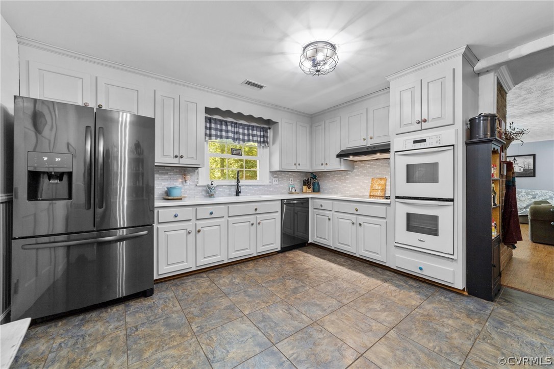 4201 Hidden Valley Road Chester, VA 23831 - Photo 10 of 30 a kitchen with stainless steel appliances a refrigerator sink and cabinets