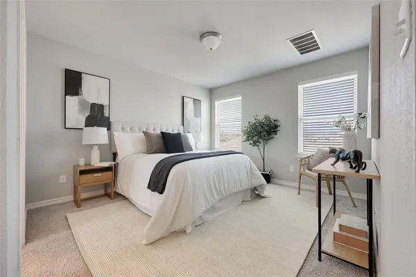 a bedroom with a bed and a table