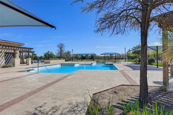 a view of a swimming pool with an outdoor space and seating area