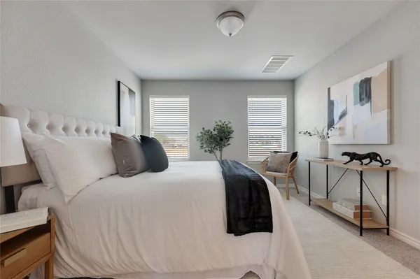 a bedroom with a bed a table and chair