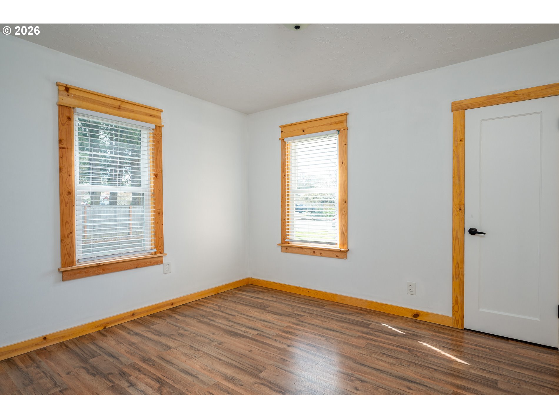 1520 North Maple Street Canby, OR 97013 - Photo 15 of 46 a view of an empty room with wooden floor and a window