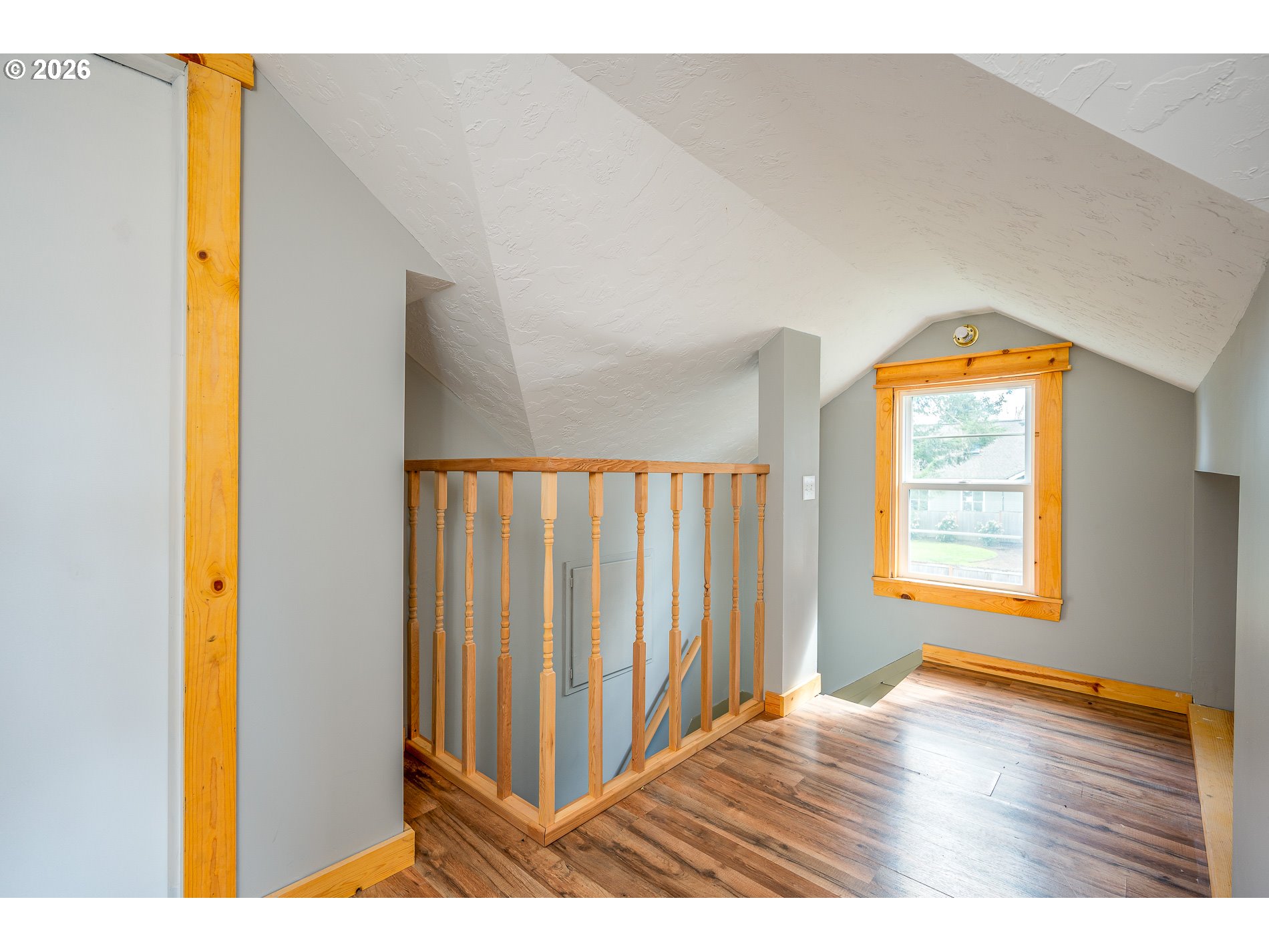1520 North Maple Street Canby, OR 97013 - Photo 22 of 46 a view of an empty room with wooden floor and a window