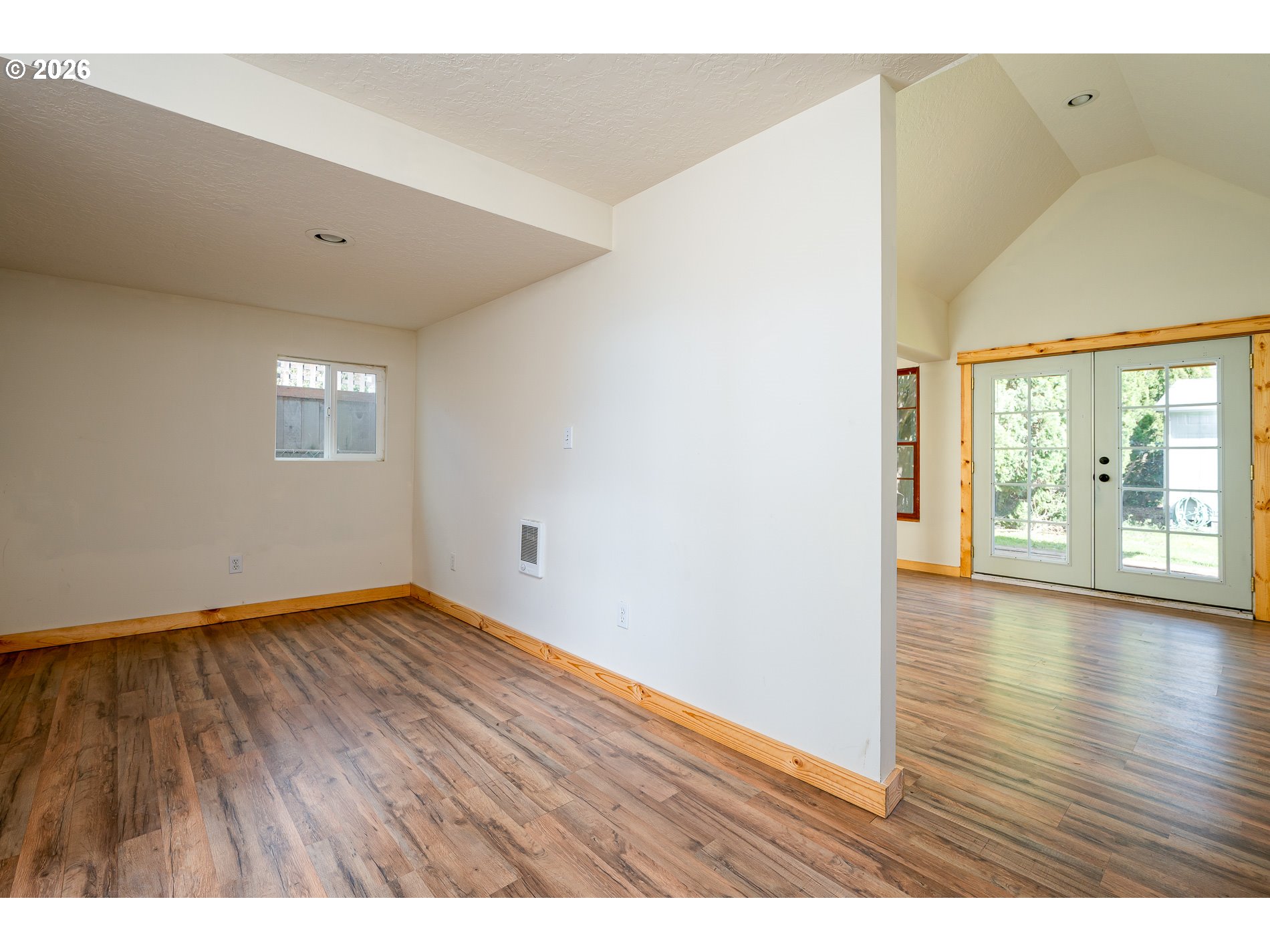 1520 North Maple Street Canby, OR 97013 - Photo 27 of 46 a view of an empty room with wooden floor and a window