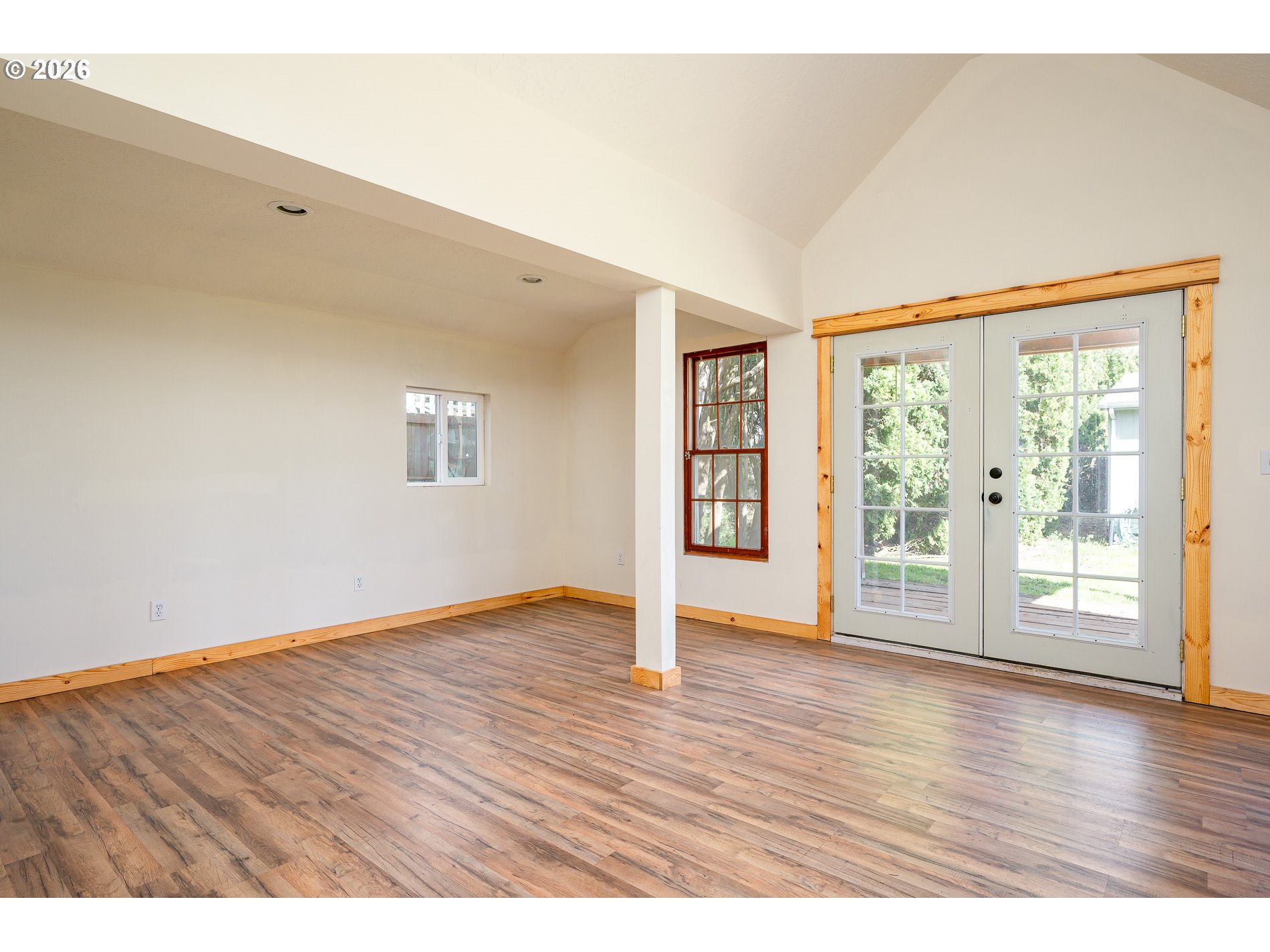 1520 North Maple Street Canby, OR 97013 - Photo 29 of 46 a view of an empty room with wooden floor and a window