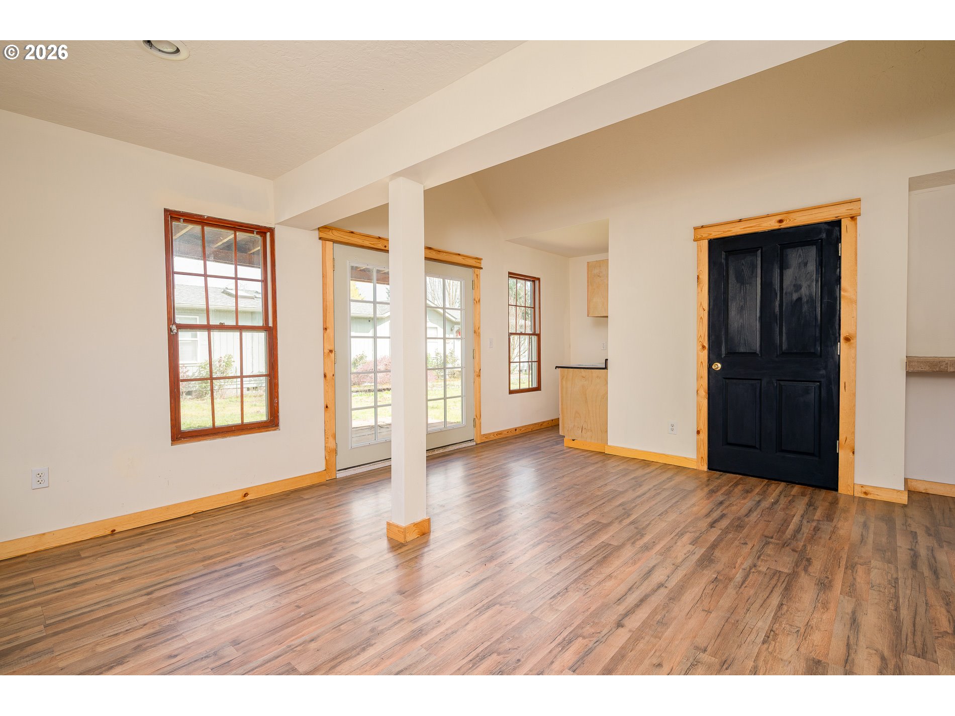1520 North Maple Street Canby, OR 97013 - Photo 31 of 46 a view of an empty room with window and wooden floor