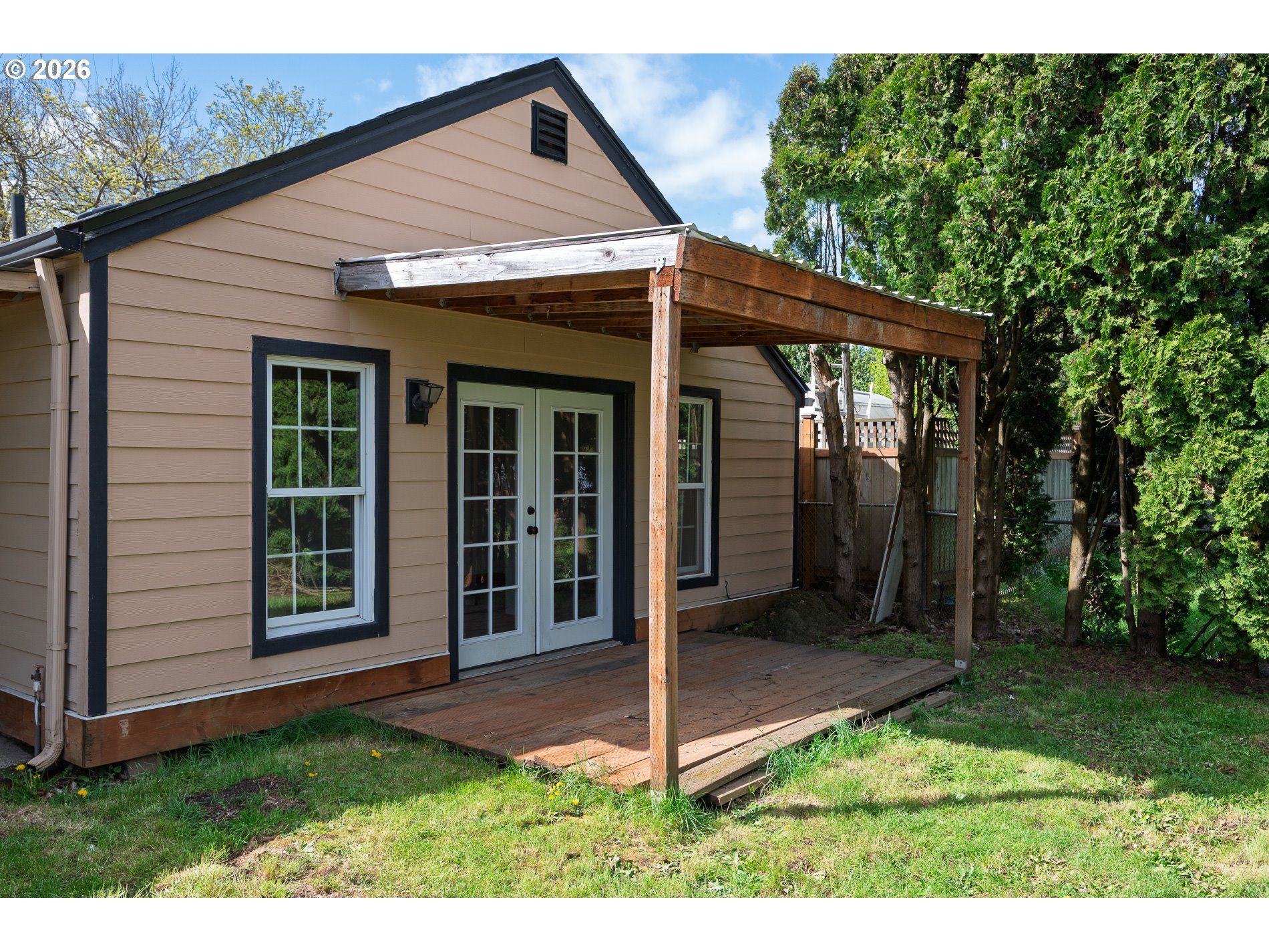 1520 North Maple Street Canby, OR 97013 - Photo 45 of 46 a view of a backyard with large windows and a yard